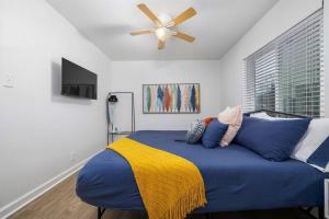 a bedroom with a blue bed with a ceiling fan at Vulcan’s Hideout / Colorful C2 in Birmingham