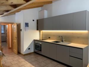 a kitchen with a sink and a stove at Italo-Svizzero in Chiavenna