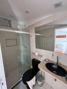 a bathroom with a sink and a shower at Apto com Arte no Pelourinho in Salvador