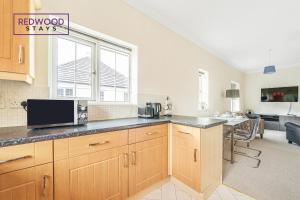 a kitchen with a counter top with a microwave at 2 Bedroom Apartment, Business & Contractors, FREE Parking & Netflix By REDWOOD STAYS in Basingstoke