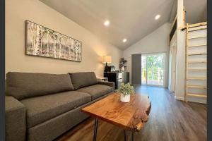 a living room with a couch and a table at Loft Cabin 3 - Rogue River Resort in Grants Pass