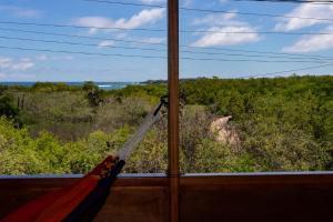 a hammock in a room with a view of the ocean at Galapagos Chalet-Buda Chalet in Puerto Ayora