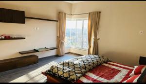 a bedroom with a bed and a large window at Private entire 3 bedroom portion in Islamabad in Islamabad