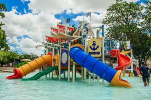 a water park with a water slide in the water at Thermas Hotel Mossoró in Mossoró