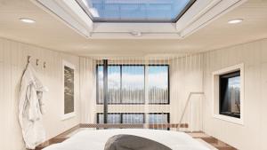 a bedroom with a bed and a skylight at BoraVilla - La terra - Cantons-de-l'Est in Bury
