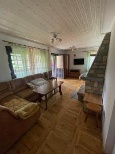 a living room with a couch and a table at Willa Maria in Kościelisko