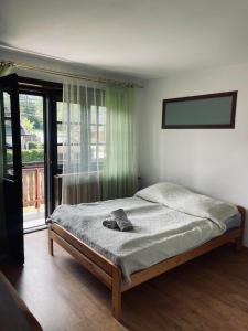 a bedroom with a bed and a large window at Willa Maria in Kościelisko