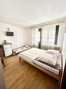 a bedroom with a large bed and a window at Willa Maria in Kościelisko