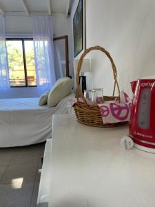 a room with a bed and a basket on a counter at Habitación para 2 personas in Valeria del Mar