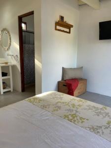 a bedroom with a bed and a sink and a mirror at Habitación para 2 personas in Valeria del Mar