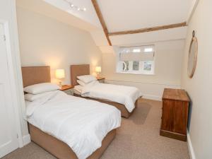 a bedroom with two beds and a window at Appuldurcombe Farmhouse in Ventnor