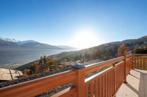 a wooden balcony with a view of the mountains at Magnificent mountain home - 756 in Crans-Montana