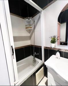 a bathroom with a bath tub and a sink at Nice apartment in the city center in Marrakech