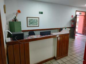 a lobby with a counter with two laptops on it at Pousada Belo Mar in Salvador
