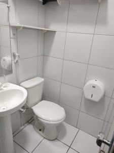 a white bathroom with a toilet and a sink at Pousada Belo Mar in Salvador +15 photos