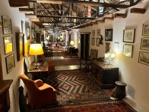 a hallway with a living room with a couch and chairs at Hotel La Castellana in Paysandú