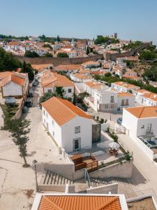 an aerial view of a town with white houses at Retiro do Castelo in Óbidos