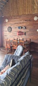 a living room with wooden walls and a table and chairs at Barra house in Inhambane
