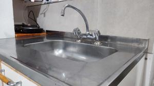 a stainless steel kitchen sink with a faucet at Monoambiente temporario Banda in La Banda