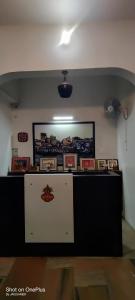 a counter in a room with pictures on the wall at The White house in Varanasi