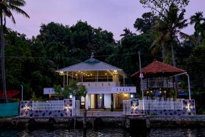 a restaurant on the water at night at LOVESHORE Homestay in Kollam