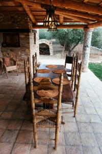 einen Holztisch und Stühle auf einer Terrasse in der Unterkunft Casa Hostalets - Renovated casa in the middle of the olive trees near the beach in Riudoms