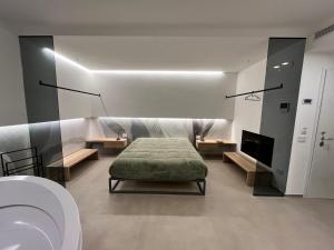 a room with a bed and a bathroom with a toilet at Seacity Suite & Stay in Monopoli