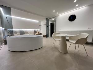 a white living room with a white table and chairs at Seacity Suite & Stay in Monopoli