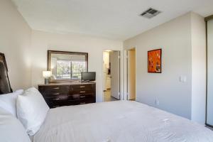 a bedroom with a bed and a dresser and a television at Walk to Dtwn Palm Springs Condo with Pool Access in Palm Springs +27 photos