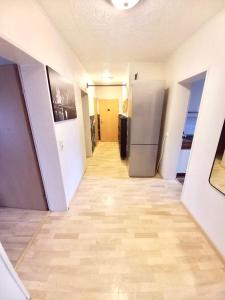 a hallway of an empty room with a refrigerator at Ida, the suburban apartment nearby Cologne in Bergheim