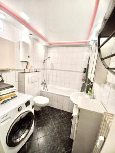 a white bathroom with a washing machine in it at Ida, the suburban apartment nearby Cologne in Bergheim