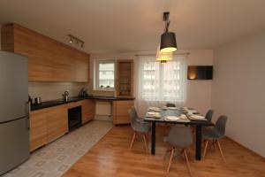 a kitchen with a table and chairs in a room at Cracow View Apartment in Krakow