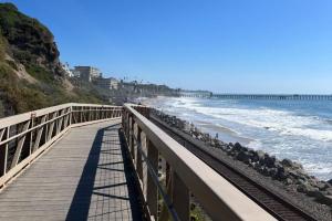 a boardwalk leading to the beach with a pier at Sea View Escape Unit #2 in San Clemente
