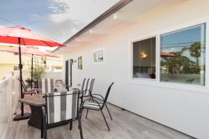 a patio with a table and chairs and a window at Bright Ocean View Escape Unit #1 in San Clemente +17 photos