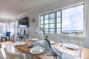a dining room with a table and a large window at Ocean View Hideaway Unit #3 in San Clemente