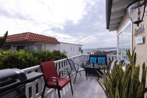 a patio with chairs and tables on a balcony at Ocean View Hideaway Unit #3 in San Clemente