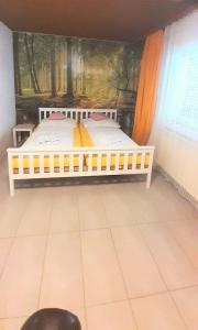 a white bed in a room with a painting on the wall at Villa Fortuna Natur in Lackenhof