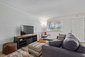 a living room with a couch and a flat screen tv at New remodeled home on golf course in Mesa