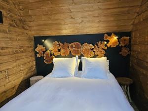 a bedroom with a bed with teddy bears on the wall at Les Flors - Hotel Rural & Cabanyes in Gramós