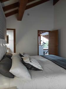 uma cama grande com almofadas num quarto em La Casa del Camino em Santiago de Compostela
