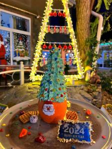 a christmas cake with a christmas tree on top of it at Qafqaz Fountain Villa in Gabala