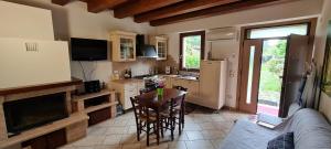 a kitchen with a table and a living room at Casolare 1898 in Pesaro