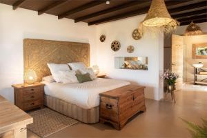 una camera con un grande letto con testiera in legno di La Finquita a Tías