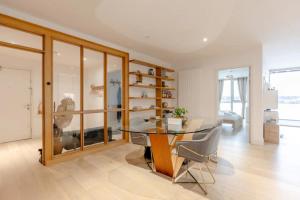 a dining room with a glass table and chairs at Charm & Convenience 3 Bed Near ExCel London in London