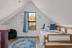 a bedroom with a bed and a window at Bear Sky Cabin in Big Bear City