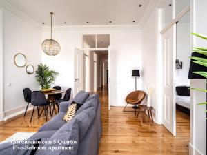 uma sala de estar com um sofá azul e uma mesa em Akicity Santarém Serene em Santarém