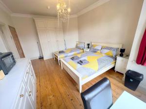a bedroom with a bed and a tv in it at Sutton Studio Apartments in Cheam