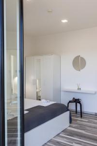 a bedroom with a bed and a glass wall at Essentia Rooms & Relax in Vasto