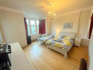 a bedroom with a bed and a piano in it at Sutton Studio Apartments in Cheam
