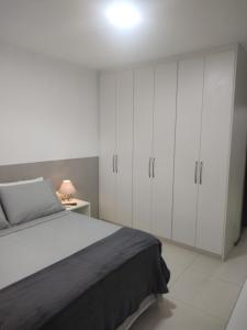 a bedroom with a bed and white cabinets at Studio In - Apt° 205 com Garagem in Brasília